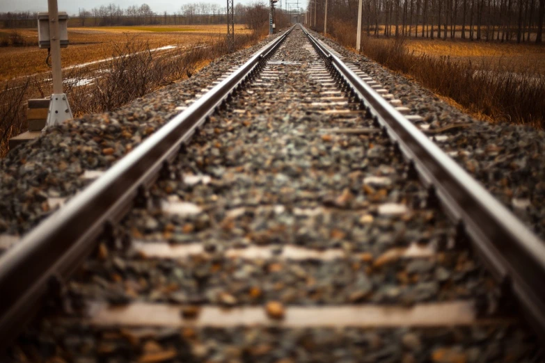 a close up of a train track near a field, by Brian Thomas, unsplash, realism, realistic footage, first person view perspective, istock, rack focus