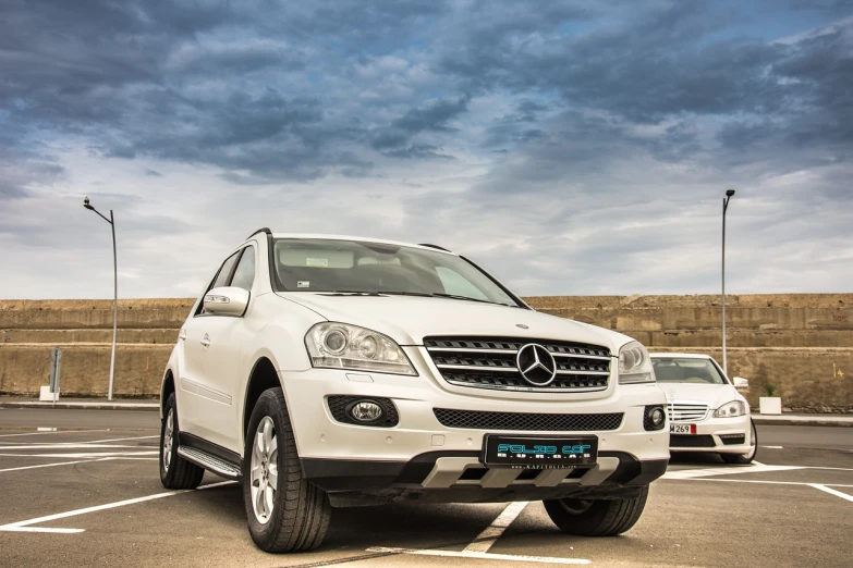 a white mercedes suv parked in a parking lot, a portrait, by Alexander Fedosav, shutterstock, taken with my nikon d 3, homemade, reportage photo, pearly sky