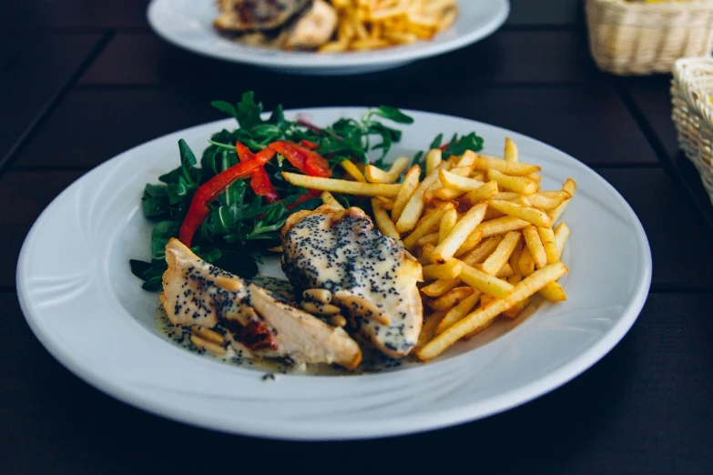 a close up of a plate of food on a table, a picture, pexels, realism, french fries, grilled chicken, dasha taran, grey