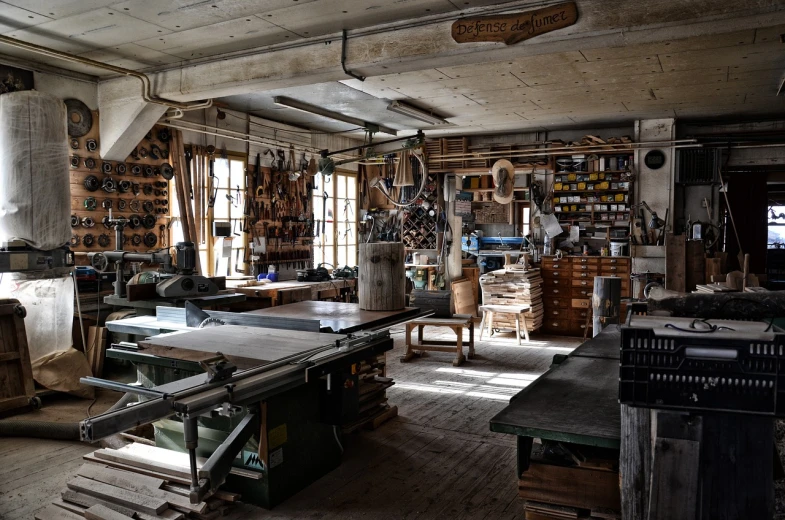 a room filled with lots of tools sitting on top of a wooden floor, by Sigmund Freudenberger, wood furnishings, beautiful creative space behind, saws, crafting