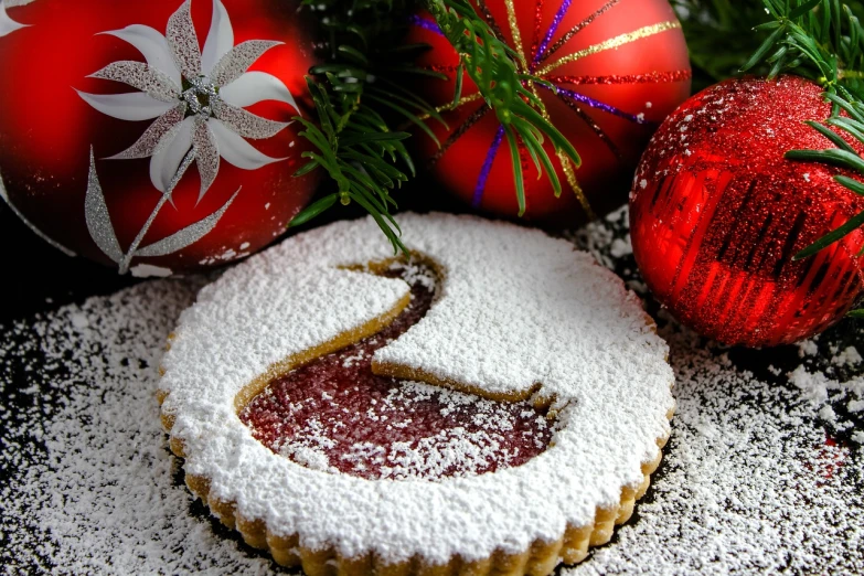 a cookie sitting on top of a table covered in powdered sugar, a photo, pixabay, holiday, a phoenix, cake, avatar image