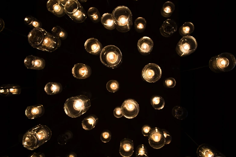 a bunch of lights that are in the dark, glass bulbs, looking upward, light circles, top down lighting