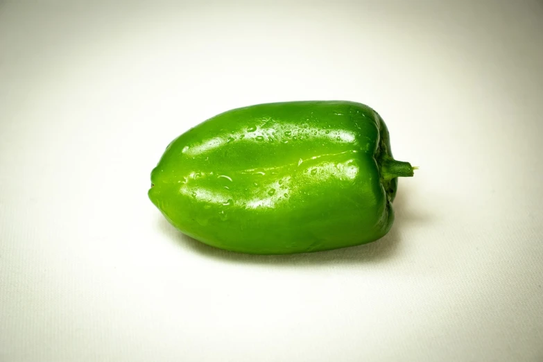 a green pepper on a white surface, by Juan O'Gorman, renaissance, sigma 1/6, beautiful smooth oval head, mexican, slight overcast lighting