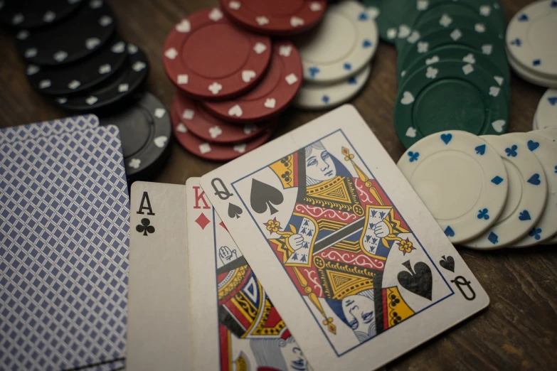 a pile of playing cards sitting on top of a wooden table, a screenshot, by Daniel Lieske, pexels contest winner, renaissance, chips, intricately detailed markings, poker face, an film still