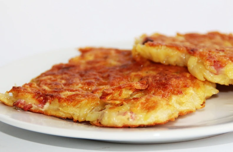 a close up of a plate of food on a table, hurufiyya, pancake short large head, kārlis padegs, very crispy, cheesy