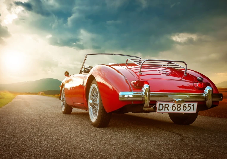 a red sports car parked on the side of a road, a picture, by Thomas Häfner, shutterstock, photorealism, retro - vintage, rays of sunshine, soft top, open road