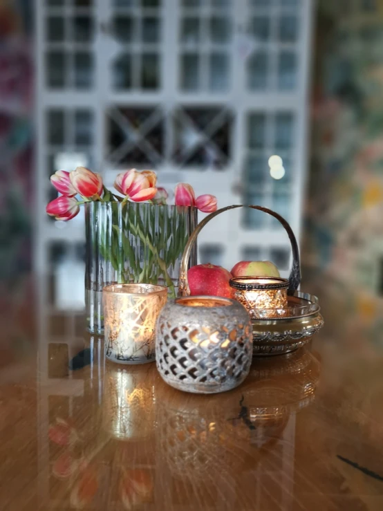 a wooden table topped with vases filled with flowers, inspired by Anna Boch, baroque, bokeh. chrome accents, fruit and flowers, with backlight, candle lit