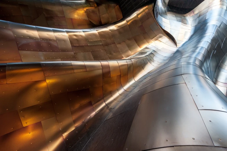 a close up of the side of a building, an abstract sculpture, unsplash contest winner, futurism, inside a cavernous stomach, reflections in copper, gleaming silver and rich colors, national geographic photo”