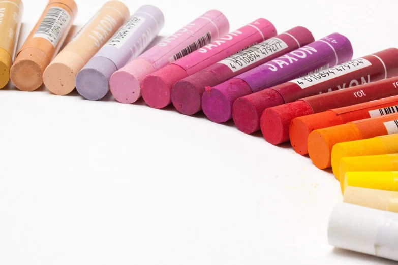 a group of crayon markers sitting next to each other, a pastel, inspired by Jan Zrzavý, professional product photography, banner, pink and orange colors, mack sztaba