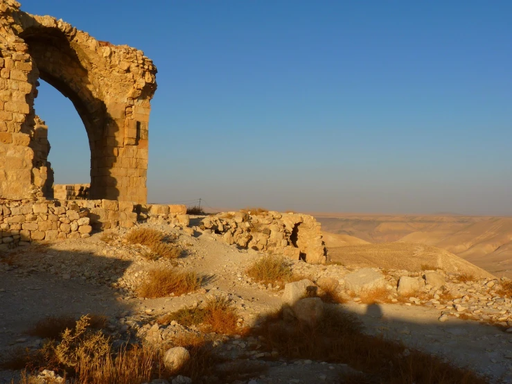 a person standing on top of a rocky hill, flickr, les nabis, ruined temple, dry archways, the panorama, raden saleh