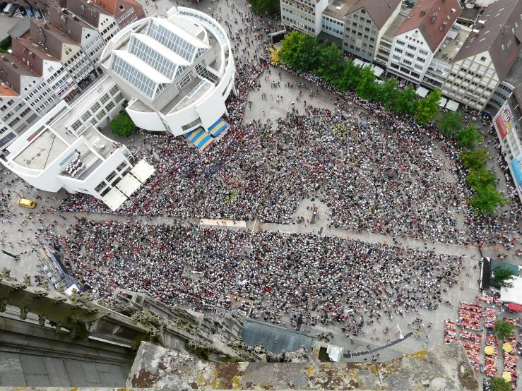 an aerial view of a large crowd of people, a photo, by Hans Schwarz, happening, switzerland, covered!, entire person!, boke