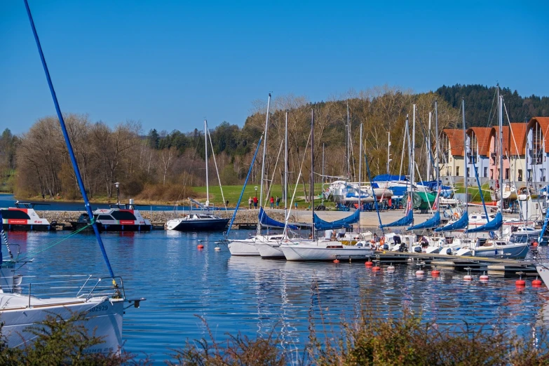 a number of boats in a body of water, a picture, by Karl Hagedorn, shutterstock, lower saxony, perfect spring day with, port scene background, bizzaro