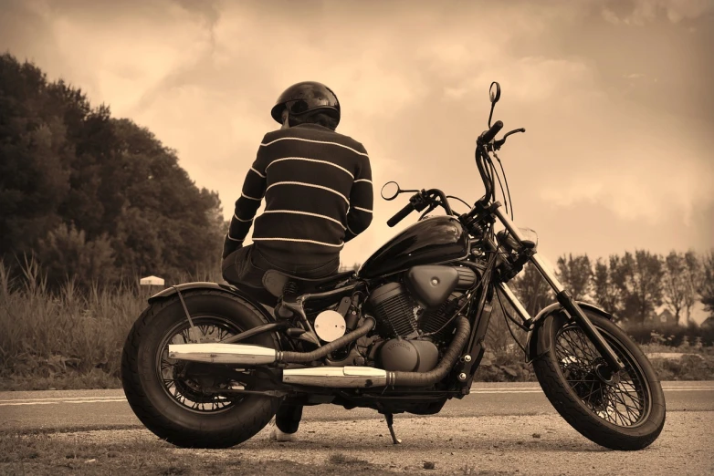 a black and white photo of a man sitting on a motorcycle, a photo, by Edward Corbett, pixabay, realism, sepia colors, stock photo, highway to hell, detailed zoom photo