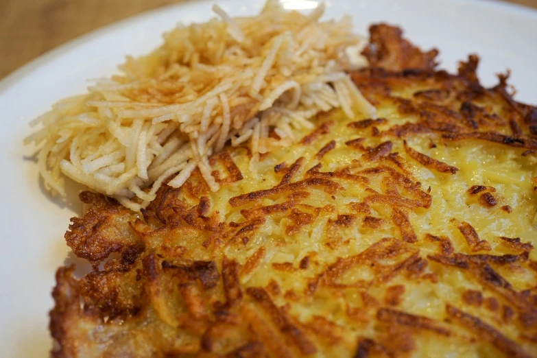 a close up of a plate of food on a table, inspired by Géza Dósa, mingei, pancakes, potato, laced, very crispy