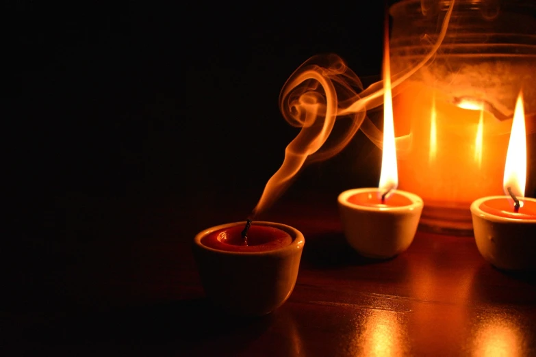 a couple of candles sitting on top of a wooden table, a picture, by Aleksander Gierymski, flickr, glowing potions, breath taking, pot, warm orange lighting