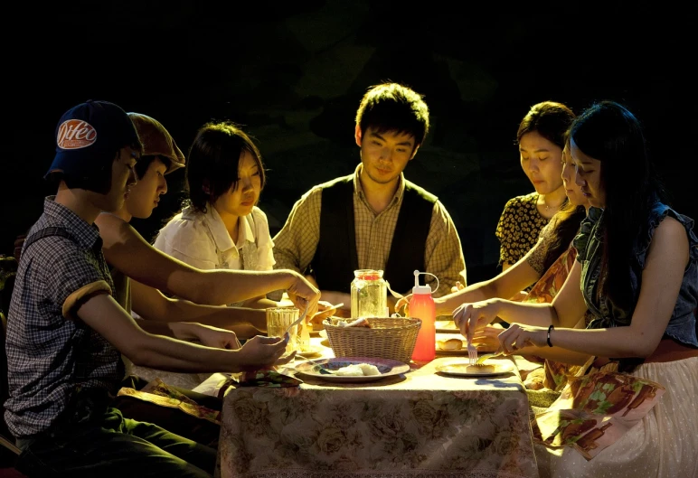 a group of people sitting around a table, by Fei Danxu, flickr, realism, perfectly lit. movie still, picnic, wenjun lin, with dramatic lighting