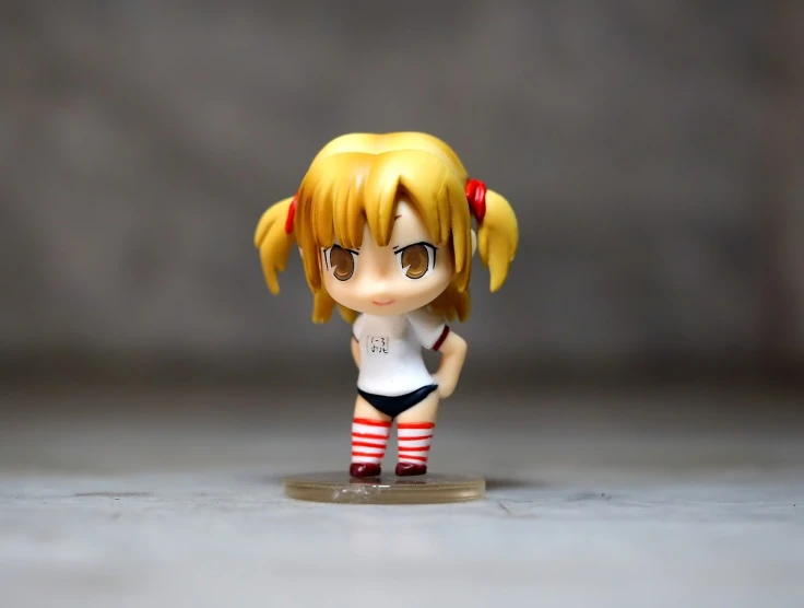 a close up of a small figurine of a girl, a picture, by Hiroyuki Tajima, flickr, blond hair with pigtails, red and white stripes, full body single character, 2 4 mm iso 8 0 0 color