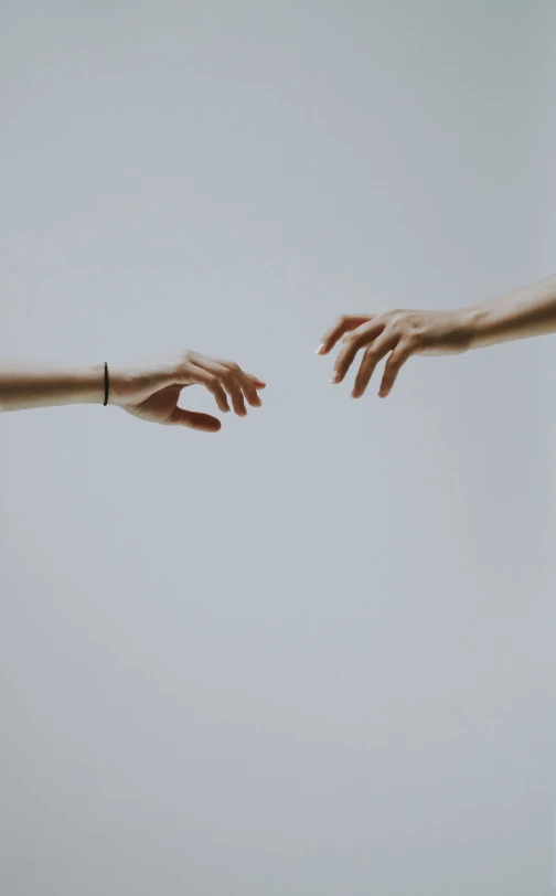 two hands reaching out towards each other, by Matija Jama, unsplash, minimalism, on grey background, viktoria gavrilenko, ignant, woman