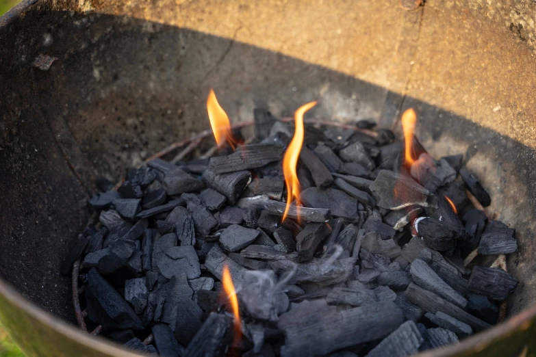 a metal bowl filled with charcoal and flames, morning detail, anthracite, gas lighting, very consistent