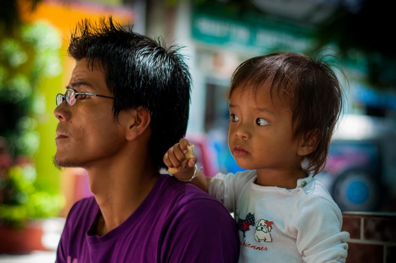 a man sitting next to a little girl on a bench, by Basuki Abdullah, flickr, sumatraism, square, closeup portrait, father holds child in the hand, ear