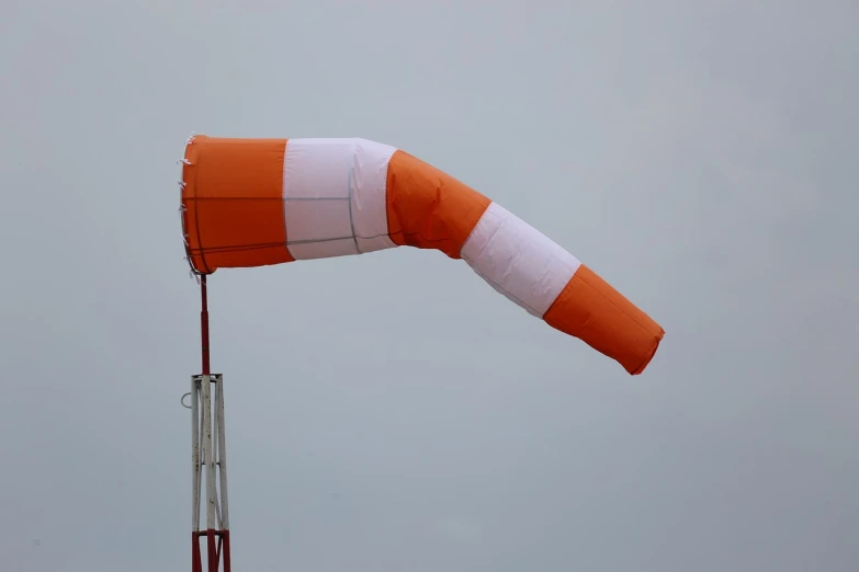 a large orange and white kite flying in the sky, a photo, water pipe, very accurate photo, construction, cannon photo