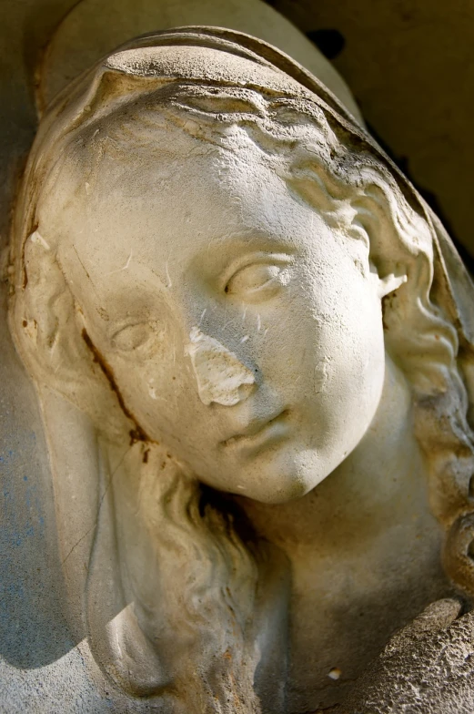 a close up of a statue of a woman's face, by Romano Vio, flickr, renaissance, london cemetery, virgin mary, angel relief, sad scene