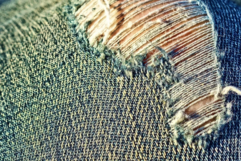 a piece of fabric that has been torn off, a macro photograph, pexels, intricate detail realism hdr, moire, grain”, worn pants