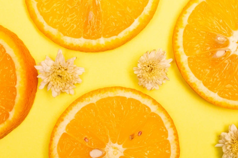 a group of orange slices and flowers on a yellow surface, trending on pexels, background image, photoshoot for skincare brand, two suns, 3 4 5 3 1