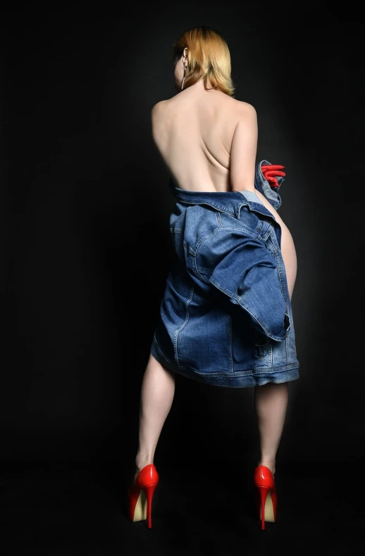 a woman wearing a denim skirt and red high heels, a stock photo, inspired by Bert Stern, hyperrealism, bare back, posing like a superhero, beautiful sexy woman photo, half body photo