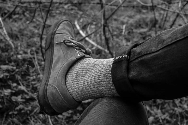 a black and white photo of someone's feet in a pair of shoes, by Raphaël Collin, zippers, wearing a fisher 🧥, grey clothes, springtime