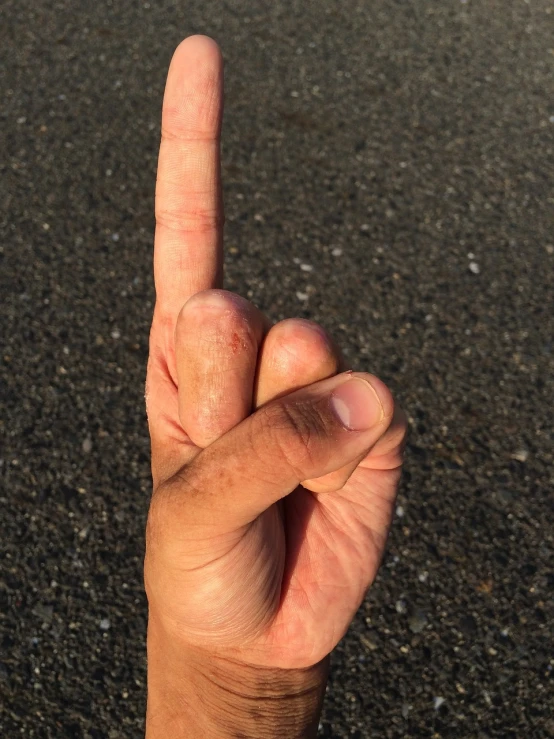 a person making a peace sign with their fingers, by Joe Stefanelli, realism, highway to hell, shot with iphone 1 0, close-up of thin soft hand, on a parking lot