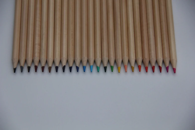 a group of colored pencils sitting next to each other, a color pencil sketch, high detail product photo, wood, multi - coloured, miniature product photo