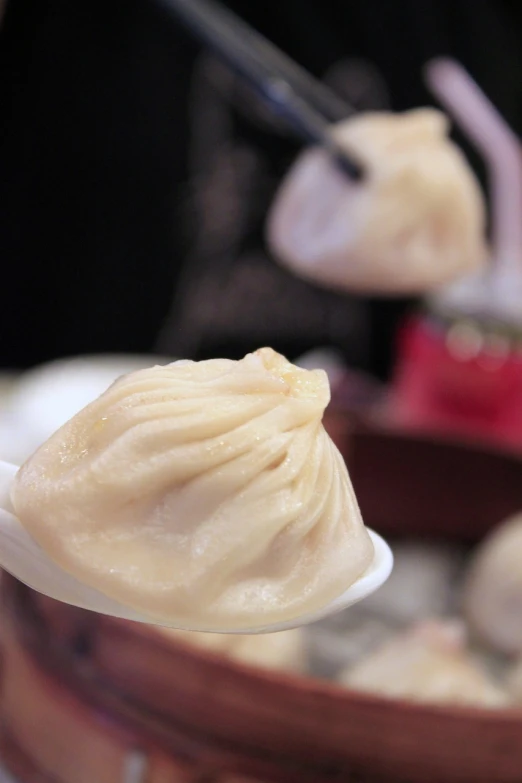 a close up of a spoon with food on it, a picture, hurufiyya, bao pnan, round portruding chin, bun ), cone