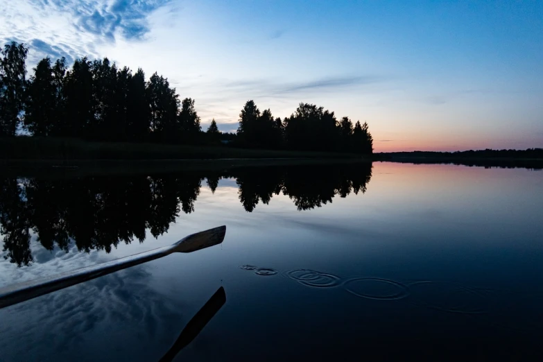 a paddle that is sitting in the water, a picture, by Jaakko Mattila, hurufiyya, twilight ; wide shot, the morning river, very accurate photo, vacation photo