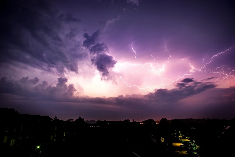 a purple sky filled with lots of lightning, a picture, from wheaton illinois, istock, dramatic white and blue lighting, taken with a canon eos 5d