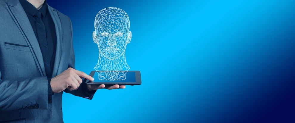 a man in a suit holding a cell phone with a drawing of a man's head on it, by Adam Marczyński, pixabay, holography, biometric humanoid robot, with a blue background, 3d wireframe, detailed face of an android