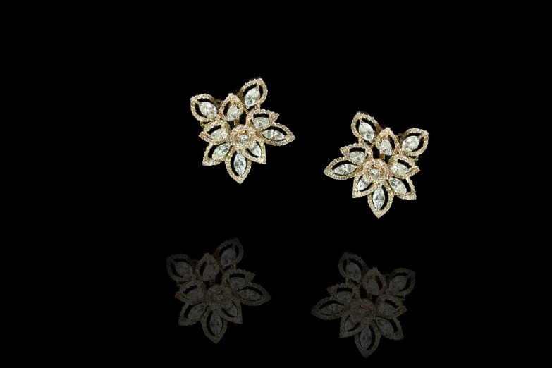 a pair of earrings sitting on top of a black surface, a digital rendering, by Youssef Howayek, pixabay, baroque, sparkling petals, front side views full, dubai, - h 1 0 2 4