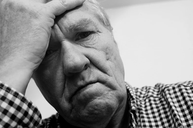 a black and white photo of a man holding his head, grumpy [ old ], 15081959 21121991 01012000 4k, looking tired, dlsr photo