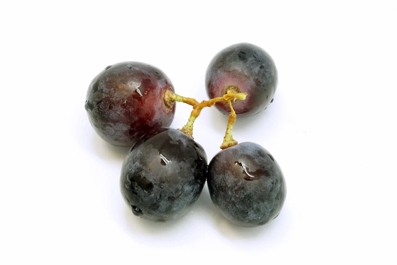 a group of grapes sitting on top of a white surface, bauhaus, istockphoto, view from bottom, three fourths view, material is!!! plum!!!