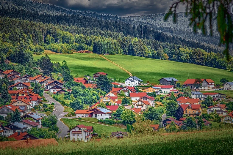 a group of houses sitting on top of a lush green hillside, by Ulrich Leman, hdr!, 1128x191 resolution, black forest, tiny village