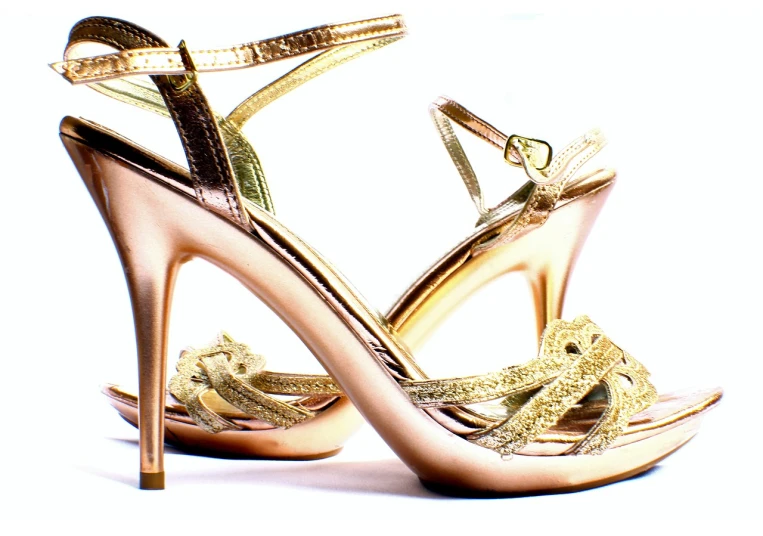 a pair of gold high heels on a white surface, by Walenty Wańkowicz, enhanced, straps, pretty, halogen