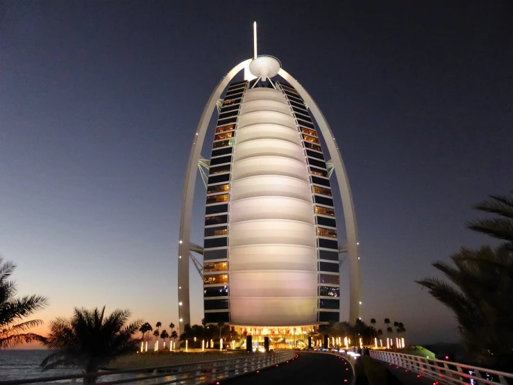 a tall building sitting next to a body of water, hurufiyya, arabian night, vacation photo, megastructure, big floppa