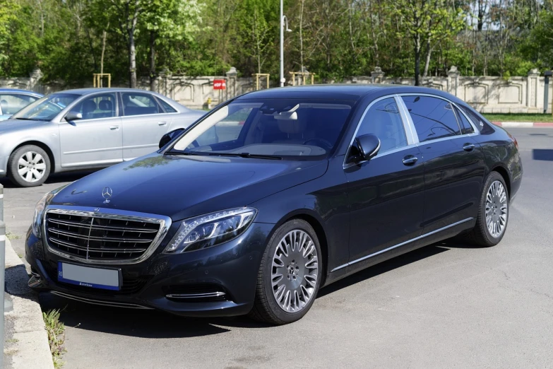 a black car is parked in a parking lot, shutterstock, baroque, aristocratic appearance, mercedez benz, 3/4 side view, 2 0 1 6