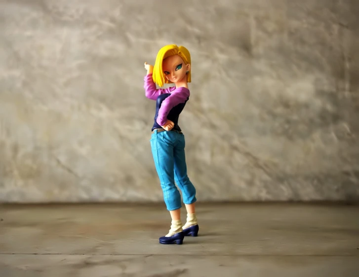a close up of a figurine of a person on a skateboard, pop art, android 18, fullbody!! dynamic action pose, stand on stone floor, saiyan girl