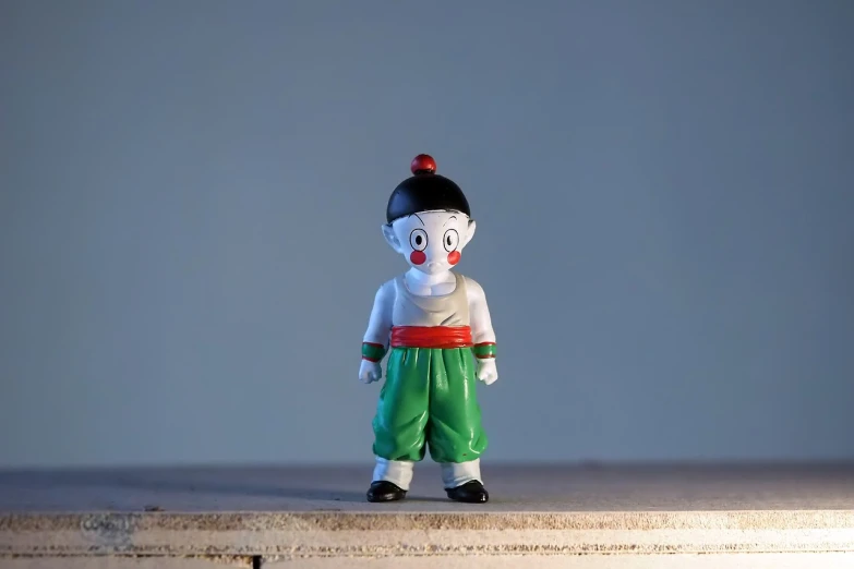 a close up of a toy figure on a table, inspired by Osamu Tezuka, sōsaku hanga, full body wide shot, dragonball, little kid, productphoto