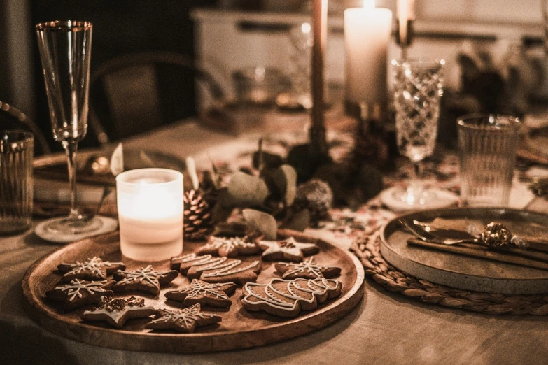 a close up of a plate of cookies on a table, by Emma Andijewska, pexels, folk art, room full of candles, wood ornaments, at a dinner table, 🤬 🤮 💕 🎀