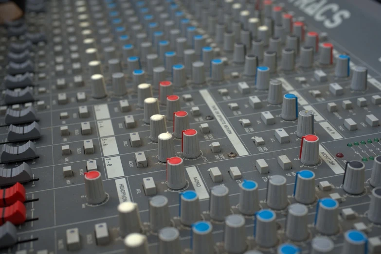 a close up of a mixing board in a recording studio, a digital rendering, by Attila Meszlenyi, highly detailed product photo, highly detailed octane render, blue and red color scheme, stock photo