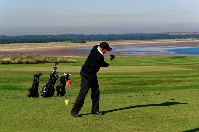 a man swinging a golf club at a golf course, by Robert Freebairn, flickr, on the coast, sharpness, working hard, gm