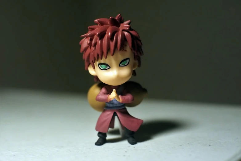 a close up of a toy figure on a table, inspired by Kamisaka Sekka, flickr, fate stay night, kakyoin, chibi proportions, very very low quality picture