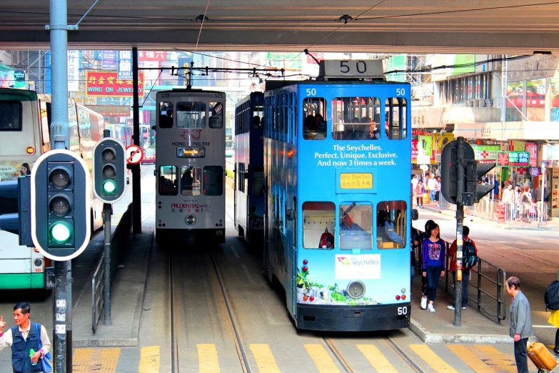 a couple of trains that are next to each other, flickr, street of hong kong, street tram, blue, 2 0 1 0 photo